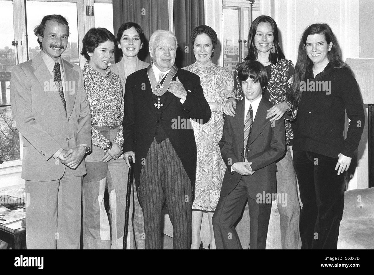 Sir Charlie Chaplin is back in his suite at the Savoy Hotel, after being knighted at the Palace, with his family. Behind him (l-r) His son-in-law Nick Sistovaris, daughters Annie and Josephine, wife Oona, son Christopher and daughters Geraldine and Jane. LUKEOTDI: Charlie Chaplin, the legend of silent film, became Sir Charles after a ceremony at Buckingham Palace. Chaplin starred in pictures such as The Kid and The Great Dictator, and was knighted in the New Year's Honours List. Stock Photo