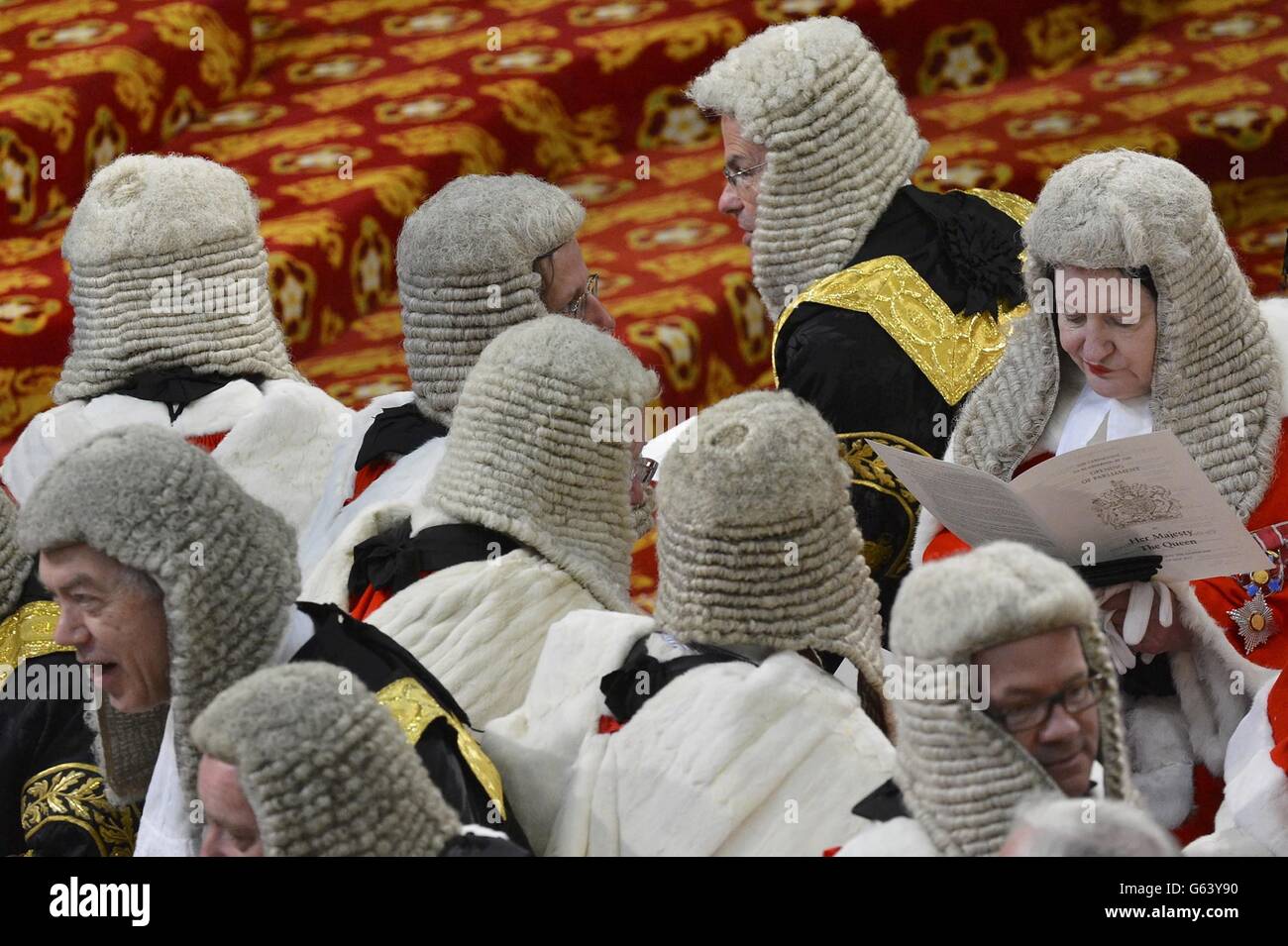 Judges sit in the House of Lords as they wait for the start of the State opening of Parliament, in the Palace of Westminster in London. Stock Photo