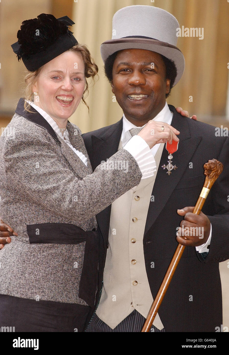 DJ Norman Jay and his wife Marie from west London pose with the MBE that Norman was awarded at Investitures at Buckingham Palace at Buckingham Palace. Jay was among some 150 people who received awards from the Queen at Buckingham Palace. Stock Photo