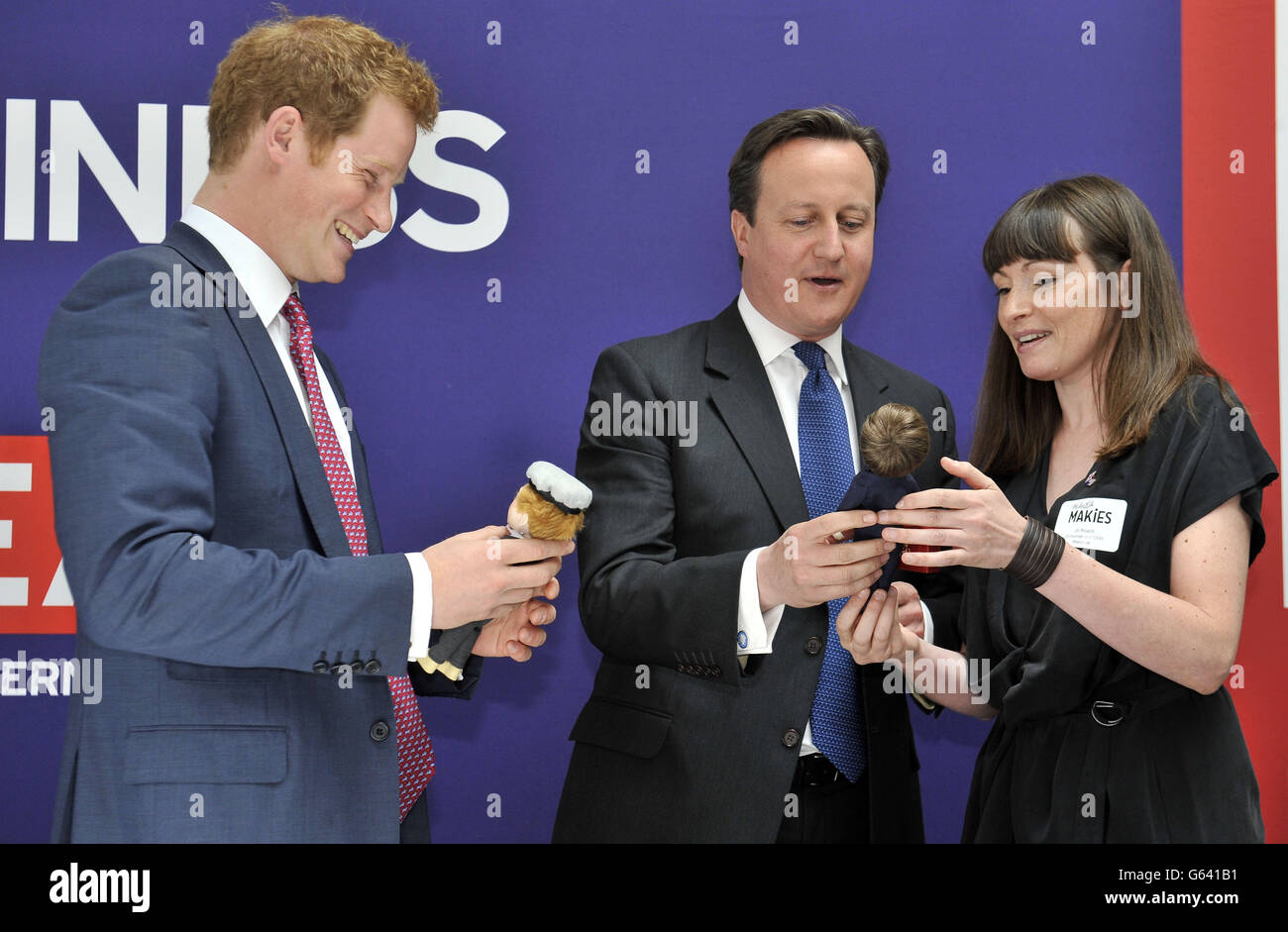 Prince Harry and David Cameron are presented with dolls by 'Makielab' company co-founder Jo Roach of themselves during part of a UK business campaign called 'GREAT' at the Milk Studios, Manhattan, New York. Stock Photo