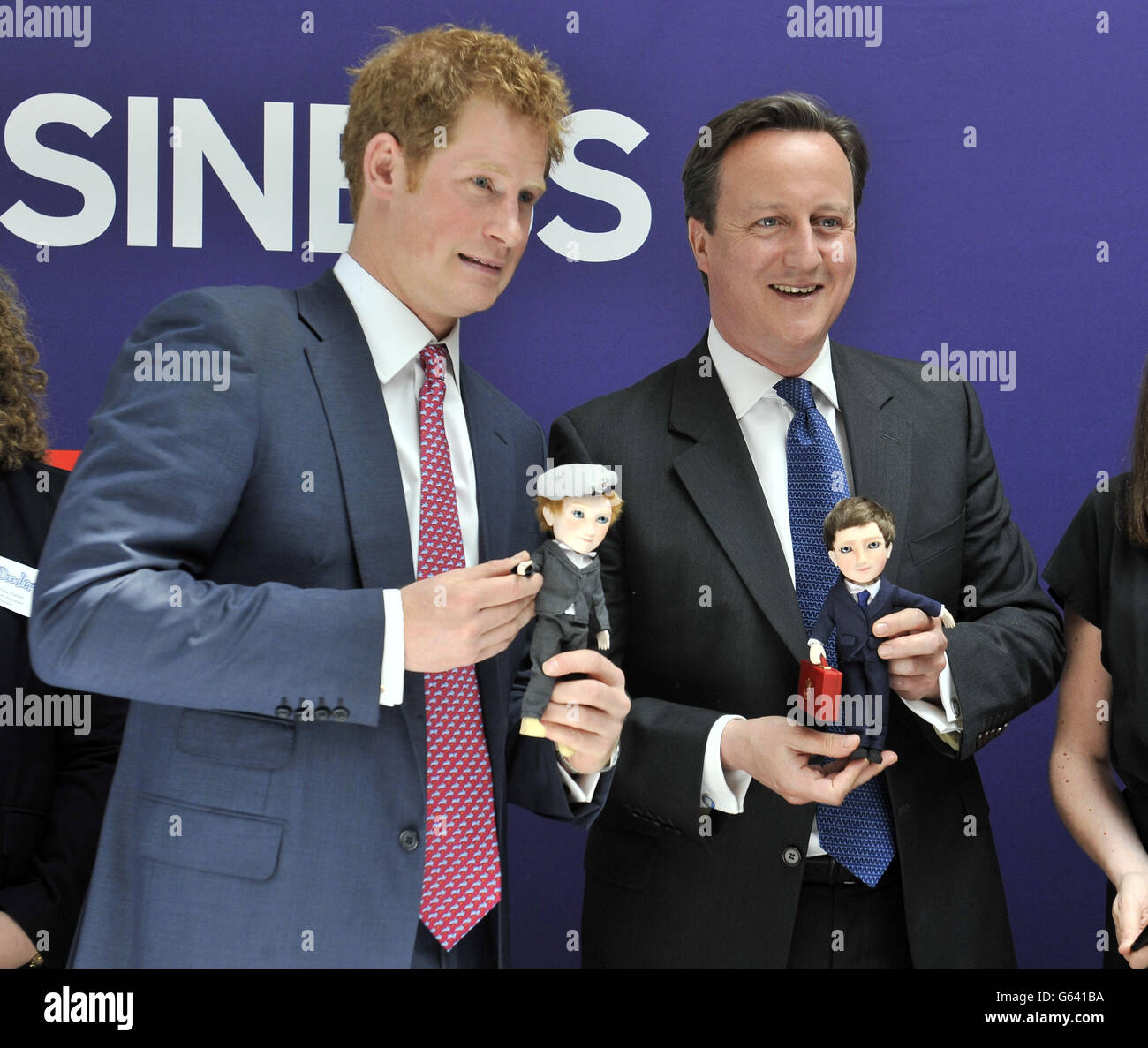 Prince Harry and David Cameron are presented with dolls by 'Makielab' company co-founder Jo Roach of themselves during part of a UK business campaign called 'GREAT' at the Milk Studios, Manhattan, New York. Stock Photo