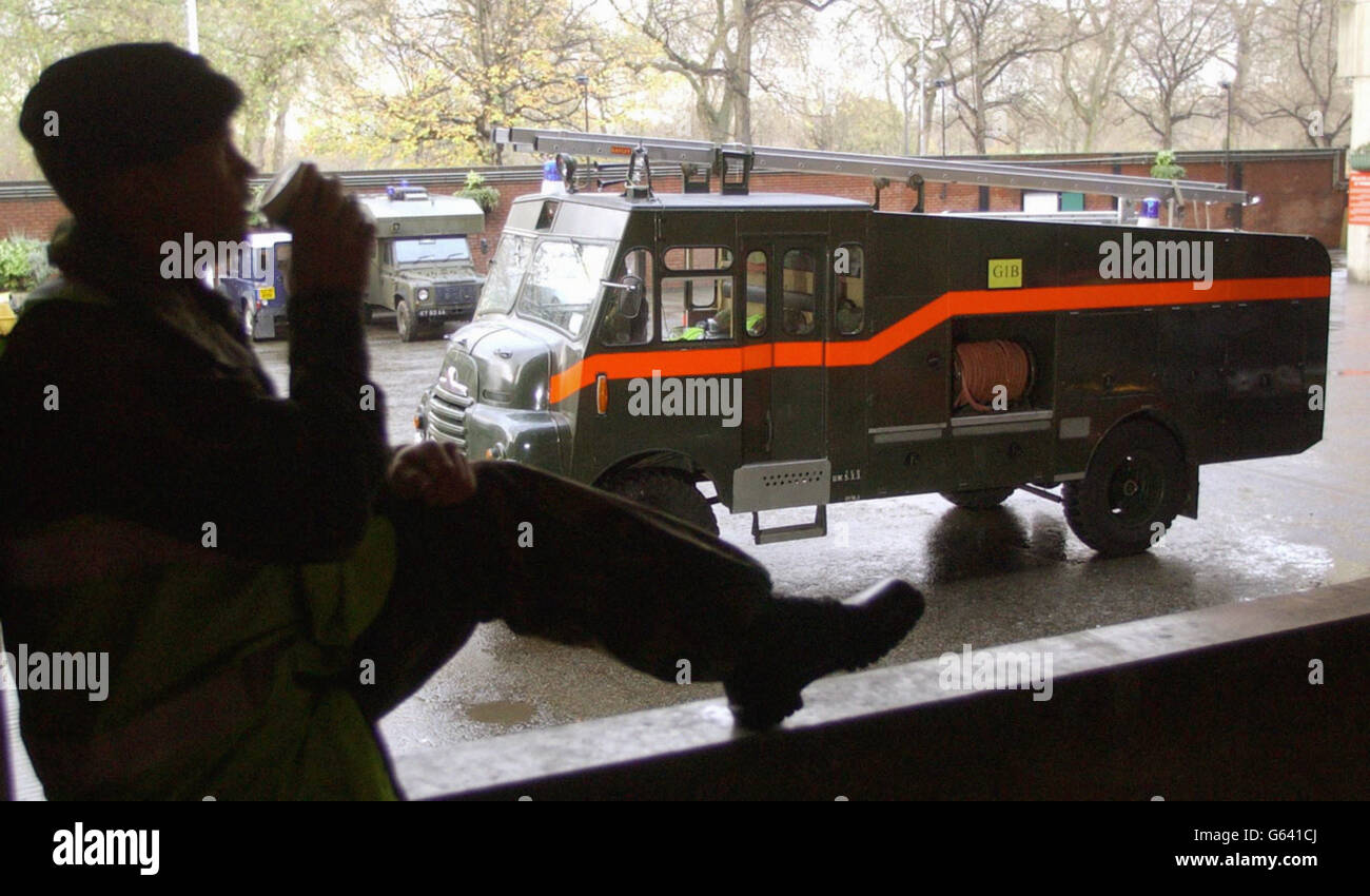 Lance Corporal Alan De Bruin, of the Household Cavalry, drinks a cup of tea in front of Green Goddess fire tender, as their 12-hour shift at the Knightsbridge Barracks in London comes to an end. * The group were part of the Armed forces that provided fire cover for the duration of the 48-hour firemens strike that is due to end at 1800hrs on Friday. Stock Photo