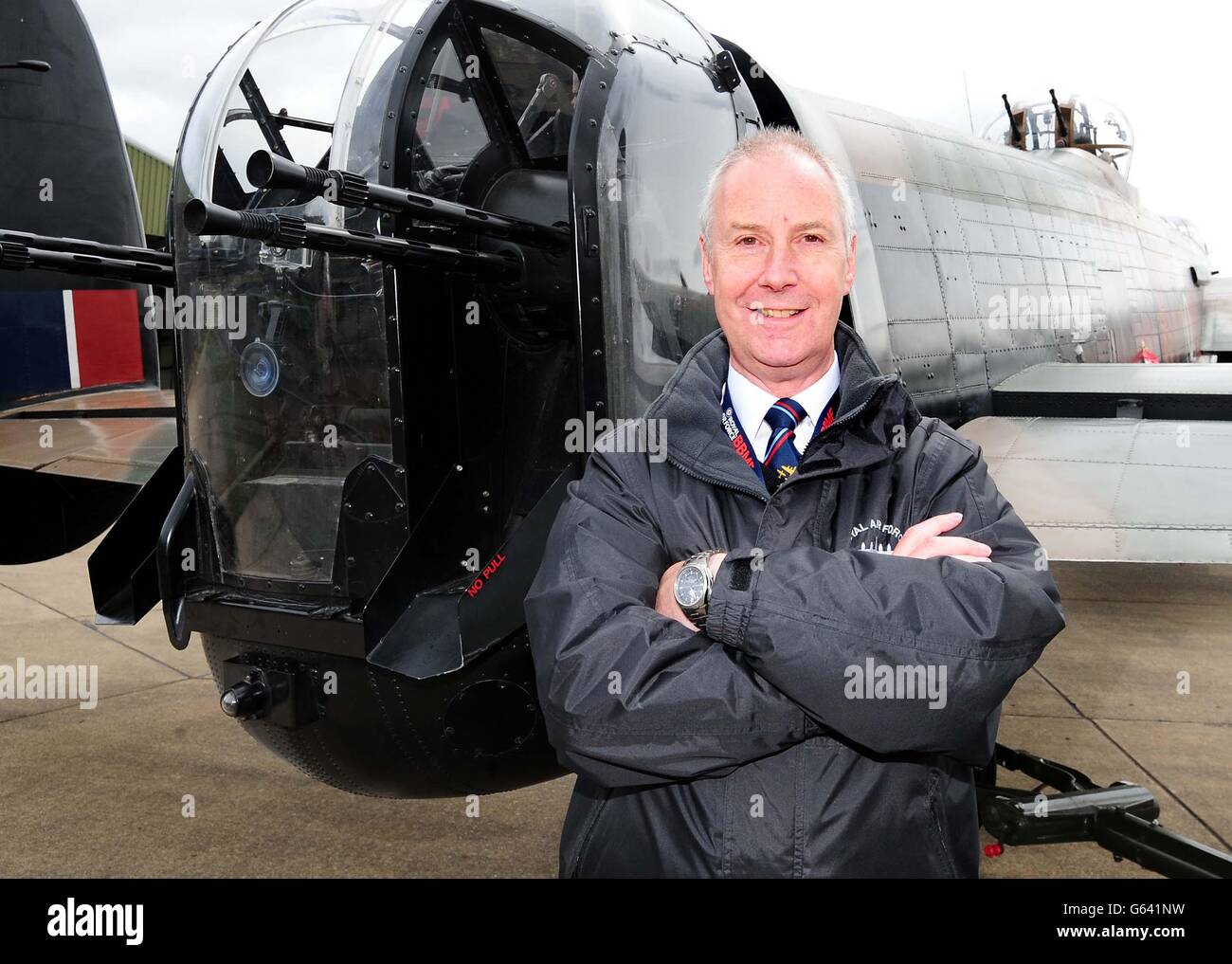 Retired Squadron Leader Clive Rowley poses with a Lancaster at RAF Coningsby. Stock Photo