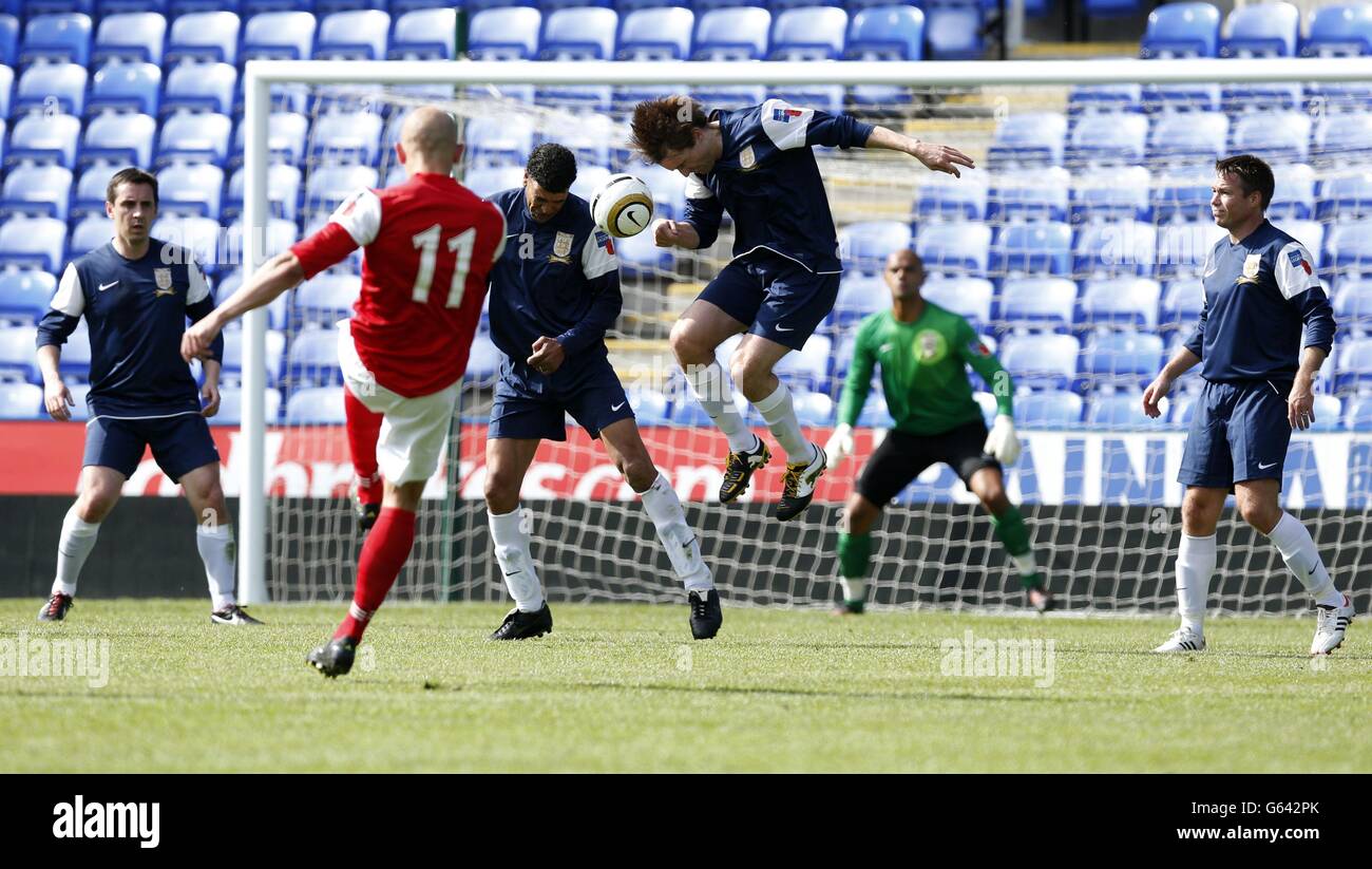 (Left to right) Gary Neville, Chris Kamara, Kevin Kilbane, and Graeme Le Saux defend a free kick from the Army's Sargent Keith Emmerson (second left) during the match between the British Army and FA Legends at the Madejski Stadium, Reading. Stock Photo