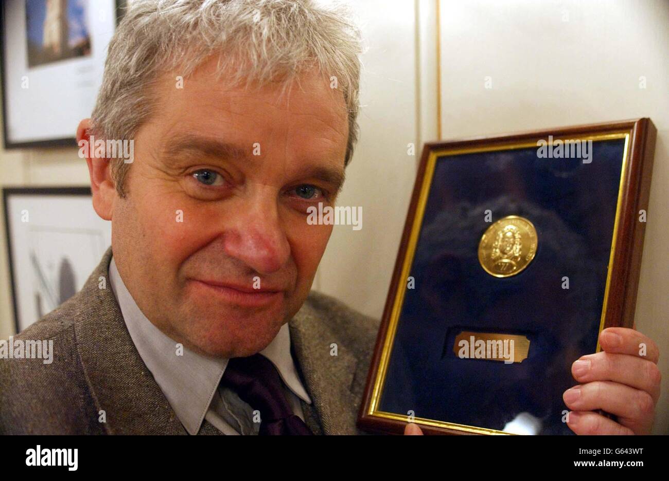 Cancer Research UK's Chief Executive, Sir Paul Nurse, proudly displays the 2002 Walpole Humanitarian Award, during a ceremony at The New Armouries, HM Tower of London. Last year's recipient was the Fire Department of New York. *040302FILER top British scientist, Tuesday February 4, 2003, spelled out his fears of genetic apartheid with people having low-grade DNA stigmatised by society. Nobel Prize winner Sir Paul Nurse, chief executive of Cancer Research UK, predicted that in 20 years time children could be given genetic identity cards at birth. See PA Story SCIENCE Genetic Stock Photo