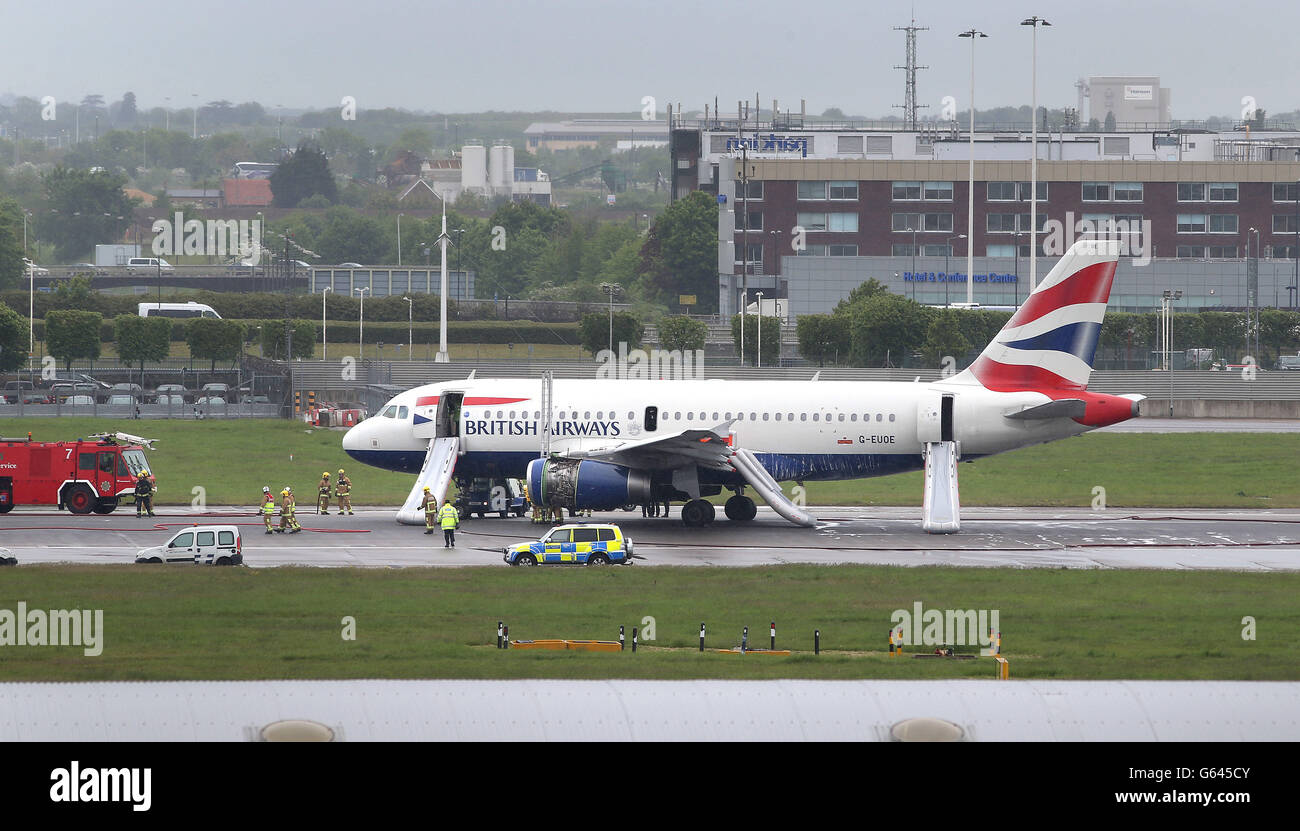 A British Airways plane surrounded by emergency vehicles after it had to make an emergency landing at Heathrow airport. Stock Photo
