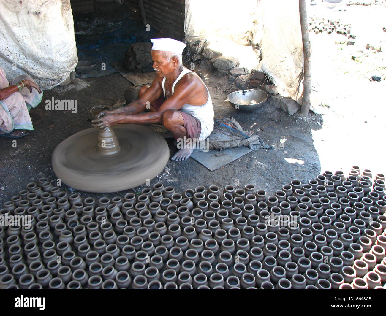 An Indian potter making pots traditionally Stock Photo Alamy