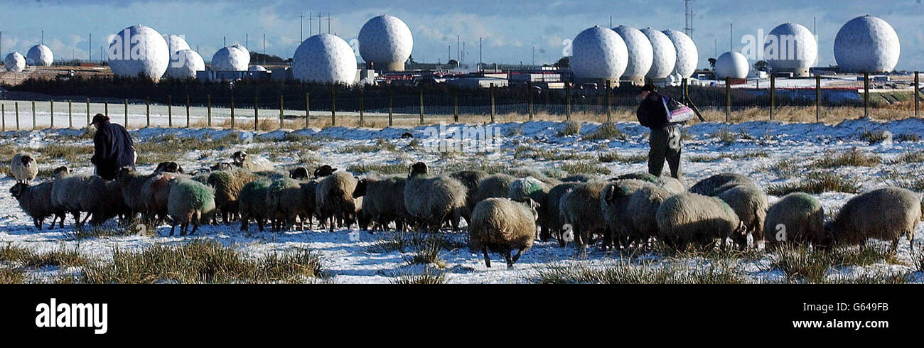 Local farm hands feed their sheep in snow covered fields around the USAF base at Menwith Hill near Harrogate. The United States Goverment is preparing to release transcripts of telephone and radio communications from Iraq relating to weapons inspections. * The Menwith Hill base listens into radio communication and other transmissions from many parts of the world. Stock Photo