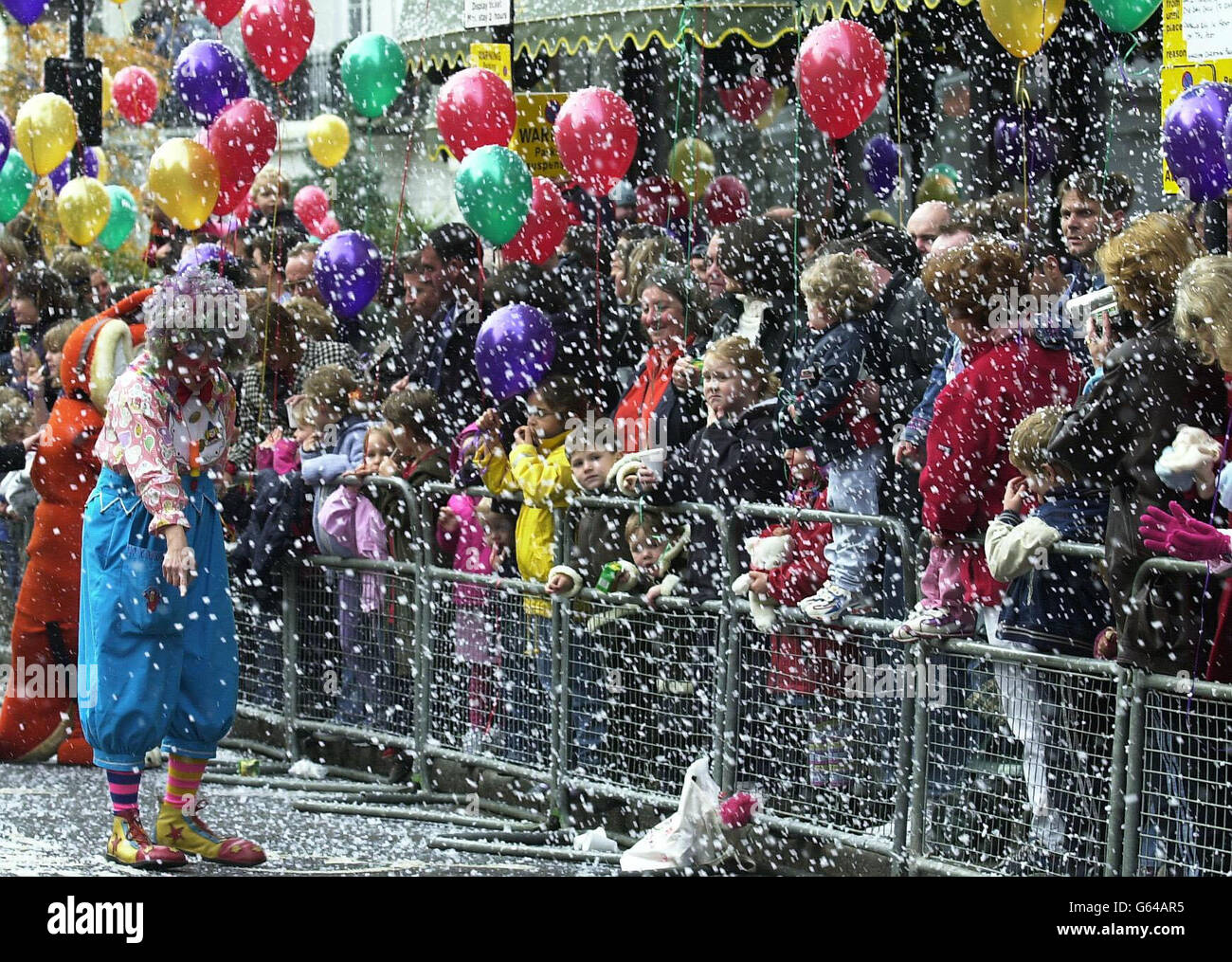 Artificial snow falls outside Harrods in London, as children wait for Father Christmas to take