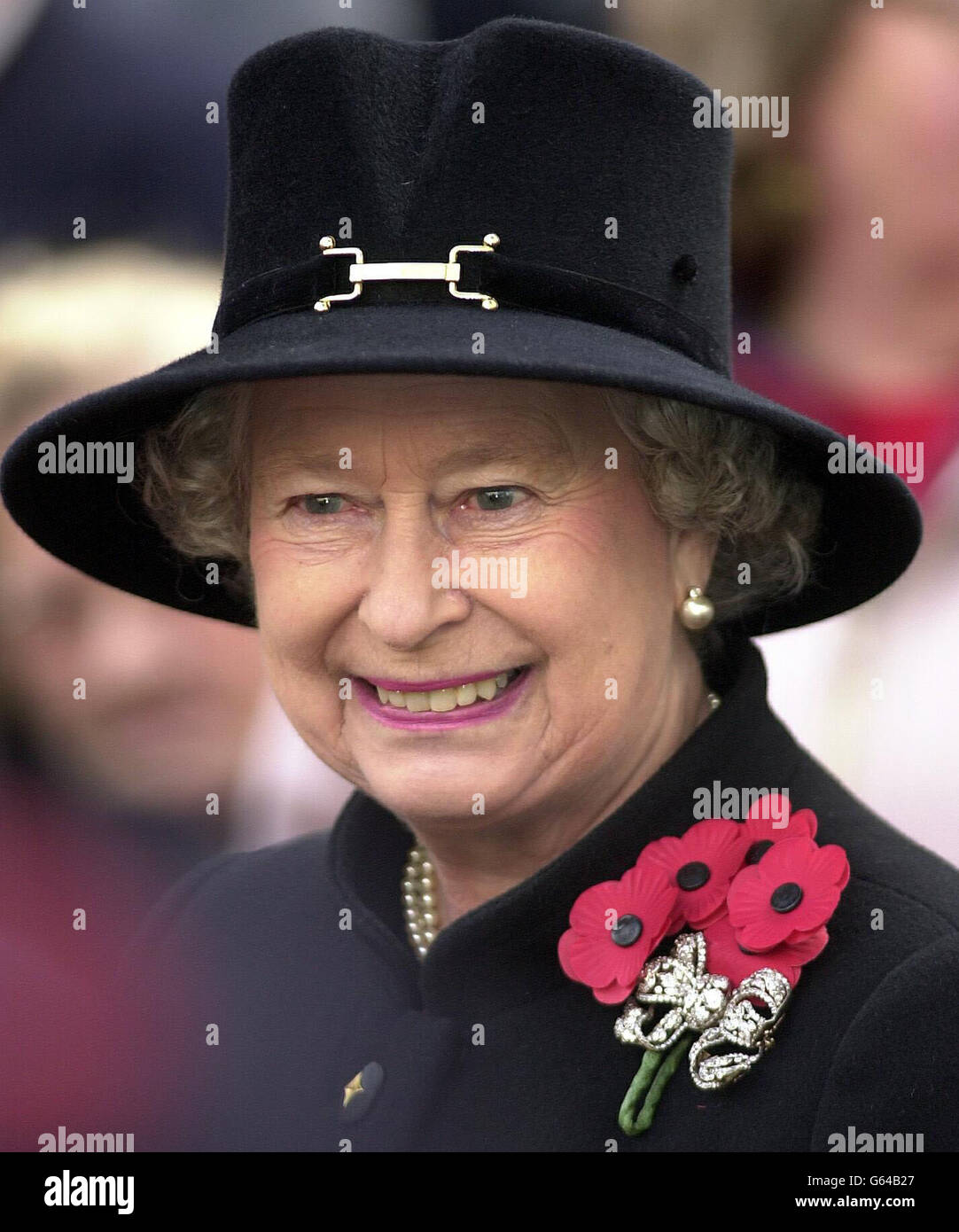Britain's Queen Elizabeth II attends the Field of Remembrance Service at Westminster Abbey. * The Queen opened the ceremony - the annual open air service in St Margaret's churchyard, held in memory of Britain's war heroes - by laying down a small wooden cross bearing a scarlet poppy in the field. Stock Photo