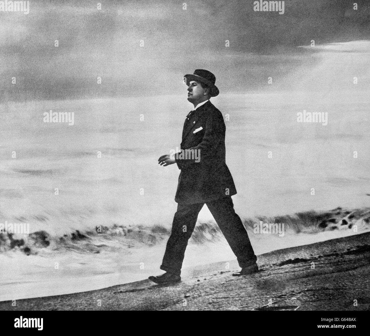 Prime Minister of Italy Benito Mussolini walks along a beach. Stock Photo