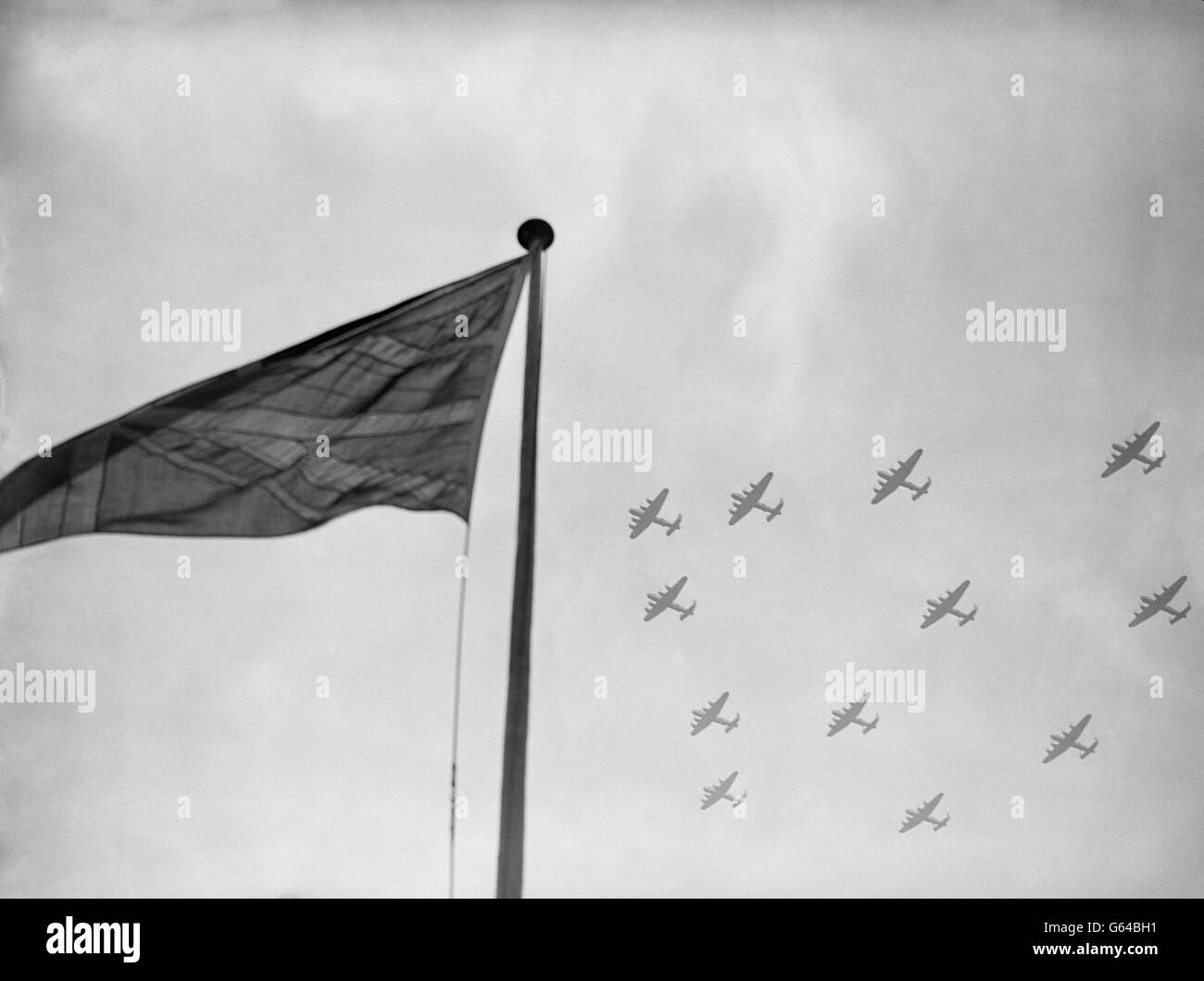 Bomber Command Lancasters, which took the war to the heart of Nazi Germany, fly in formation over the Union Jack. Stock Photo