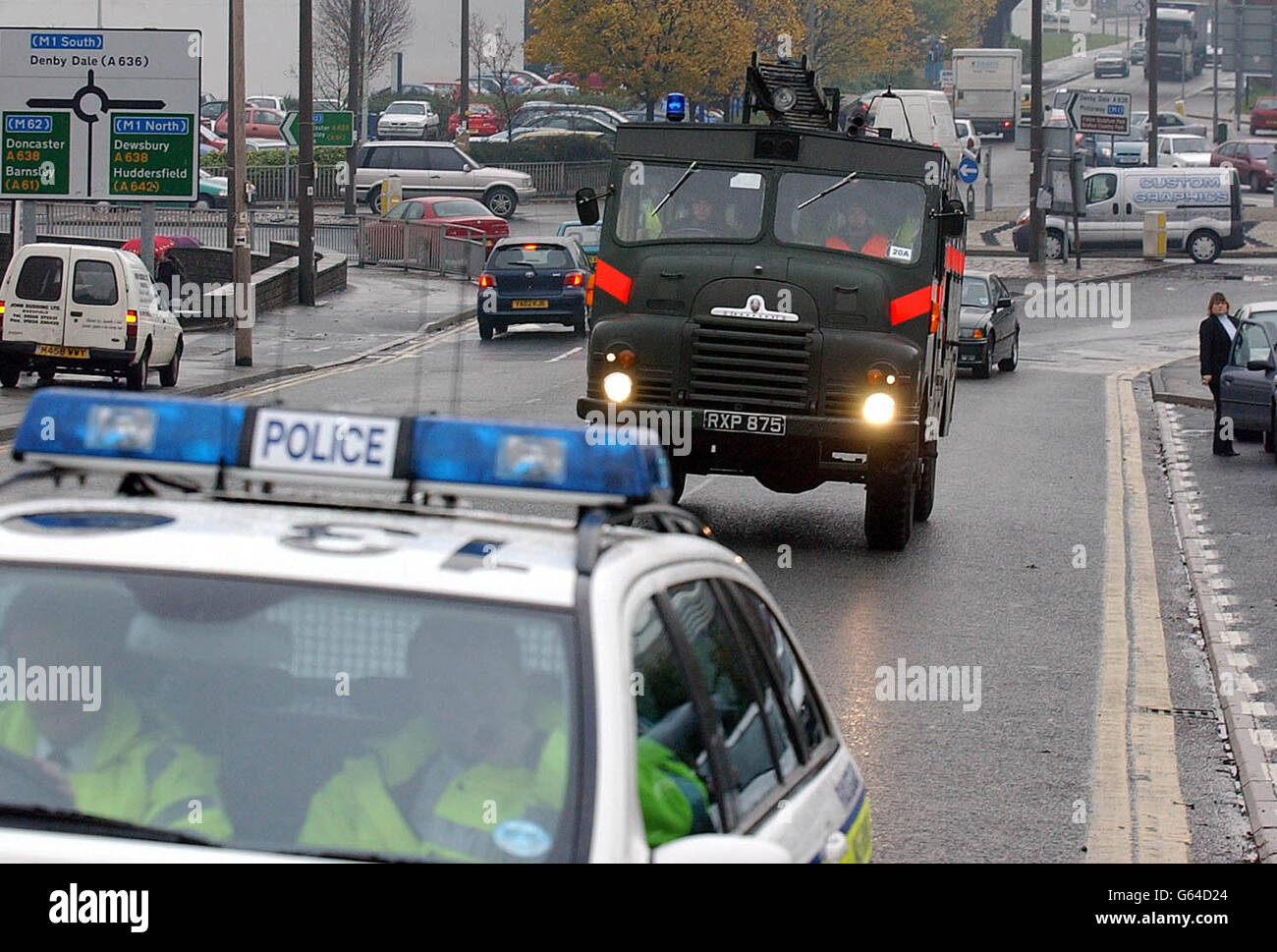 A Green Goddess is escorted by a Police car out on the road in Wakefield, ahead of the national strike by the Fire Brigades Union. Stock Photo