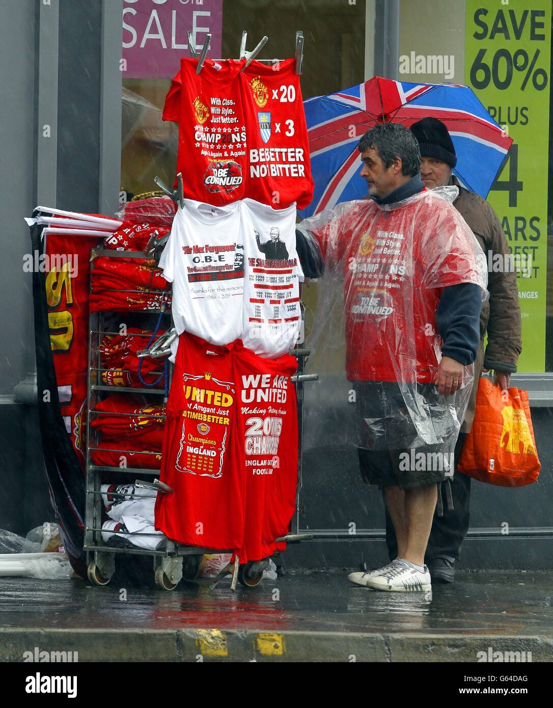 A stall holder sells Manchester United related Merchandise as rain