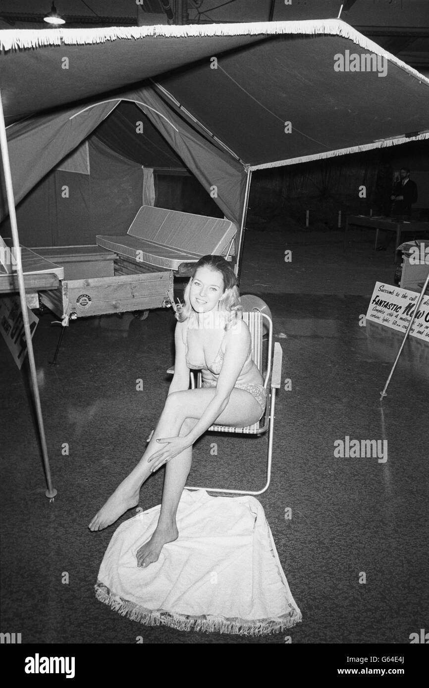 Camping exhibition - Wendy Pattenden demonstrates a tent trailer - Colex '70 - Olympia, London Stock Photo