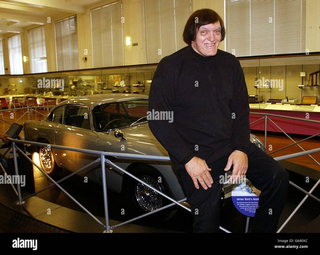 Richard Kiel, who played 'Jaws' in James Bond movies, poses with an Aston Martin from 1995 movie, Golden Eye, at the Science Museum, London. The exhibition is a retrospective of Bond memorabilia, coinciding with the launch of the new movie. Stock Photo