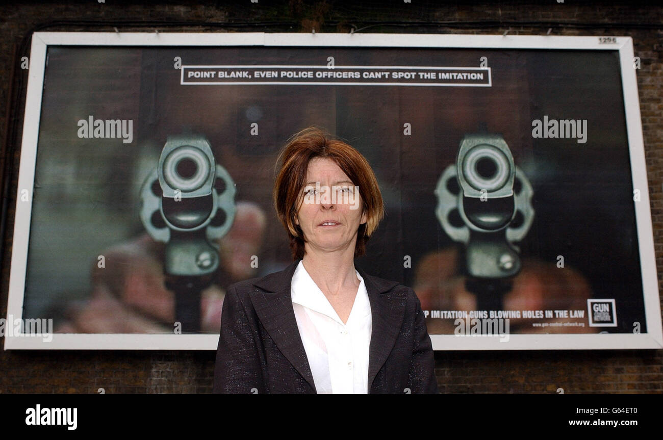 Lucy Cope of Mothers Against Guns, from Southwark whose 22 year old son Damian was shot dead outside a nightclub in Holborn in July 2002 , stands infront of one of the new posters released by the Gun Control Network (GCN) at the launch in south London. * The ads, which will appear on hoardings across London from mid-November, feature hard-hitting images which graphically illustrate how it is impossible to distinguish between real and imitation weapons, and how for as little as 50 an imitation handgun can be converted into a lethal firearm. PA Photo: Kirsty Wigglesworth Stock Photo