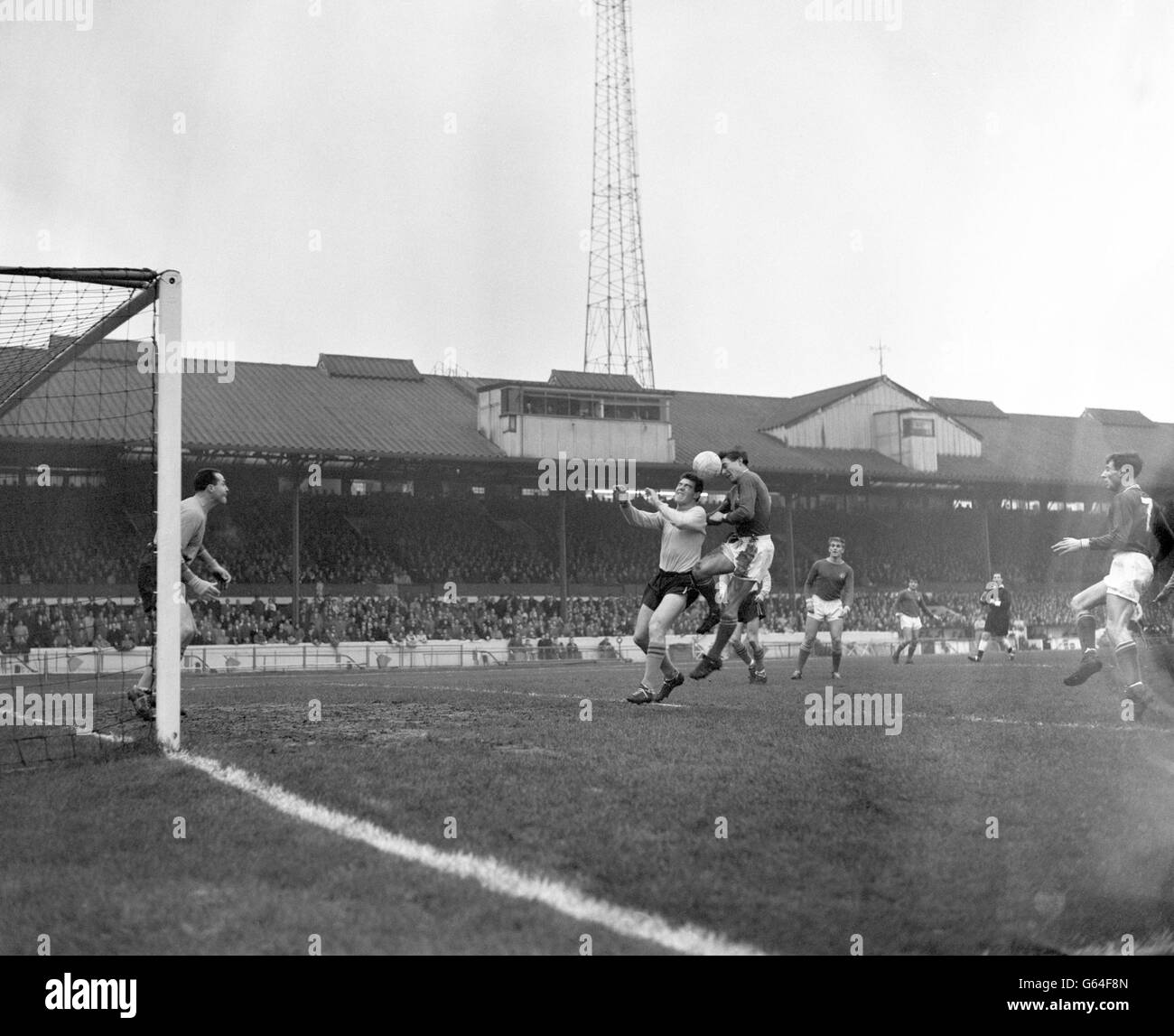 Ollie Burton, Norwich City right-half (left) and Bobby Tambling, Chelsea inside-right, both challenge for the ball during the Division Two match at Stamford Bridge, London. Stock Photo