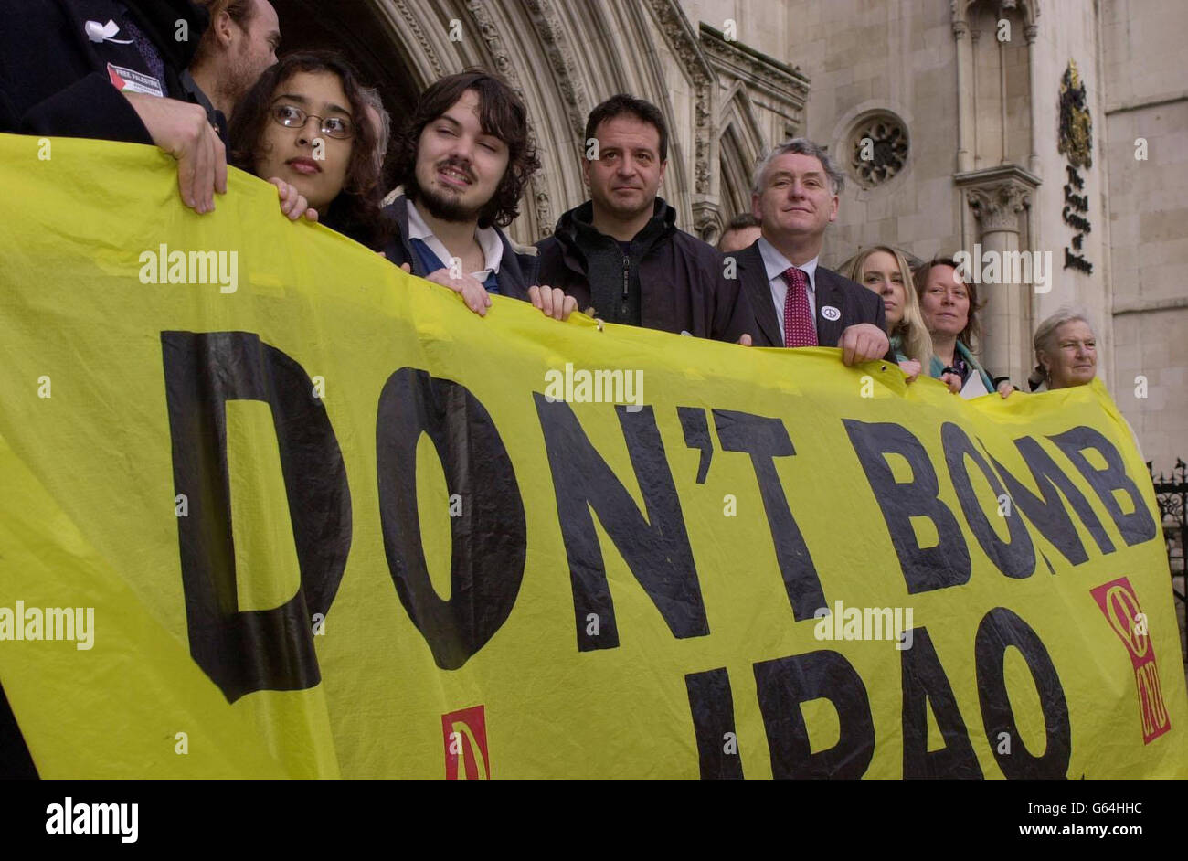Comedian and CND supporter Mark Thomas (centre) joins a group of fellow protesters outside the Royal Courts of Justice in central London, as lawyers for the peace campaign group launch a legal bid to block any action against Iraq by the UK. * The group is seeking an urgent ruling that no action can lawfully be taken against the country without the UN Security Council first passing a fresh resolution clearly authorising the use of force. Stock Photo