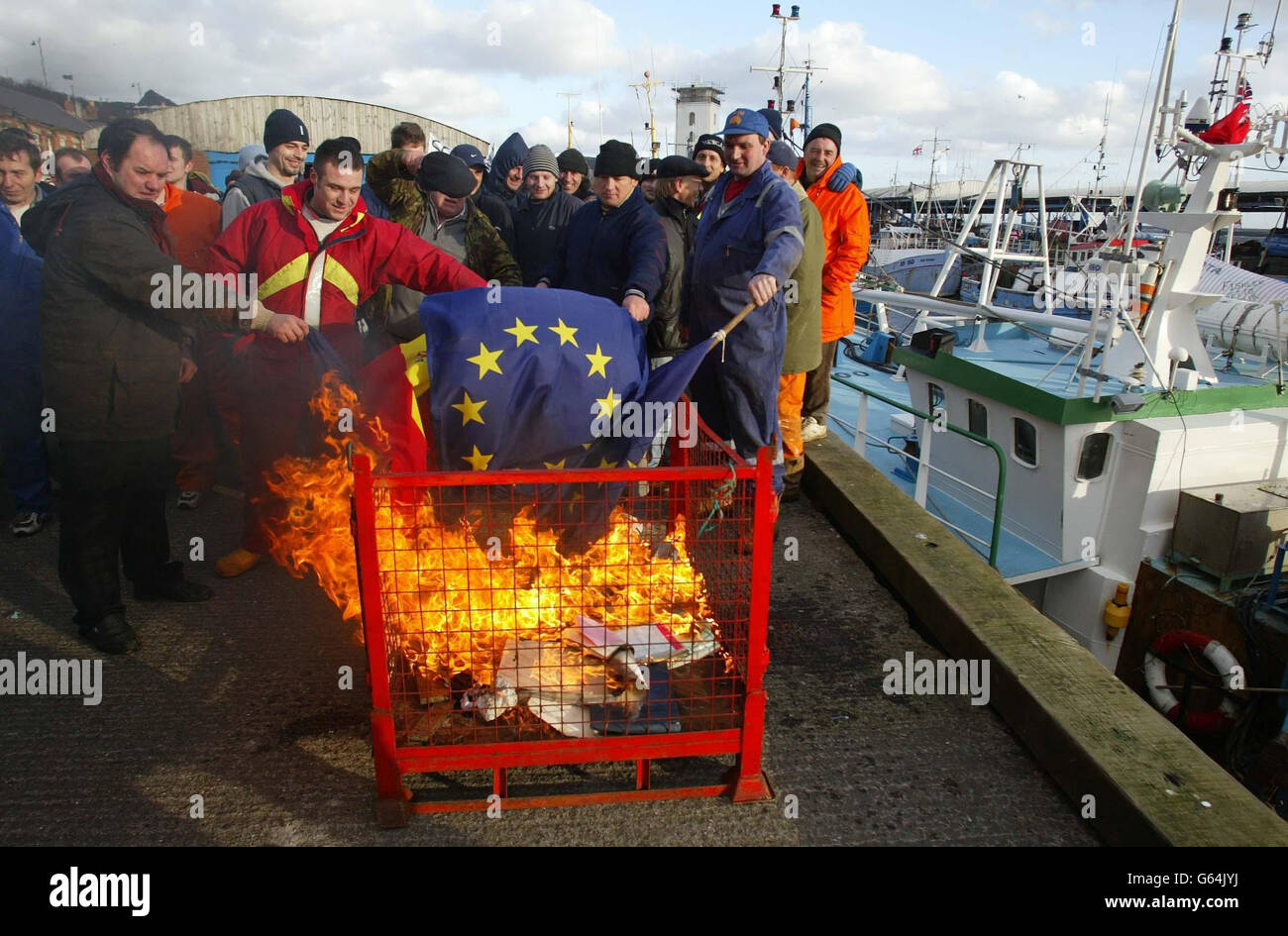 Fishermen at North Shields near Newcastle burn European and Spanish flags in protest about the possible introduction of new European quotas which they say will hit jobs on the East coast of England. * Earlier, a flotilla of fishing boats blocked the River Tyne as part of the demonstration. Stock Photo