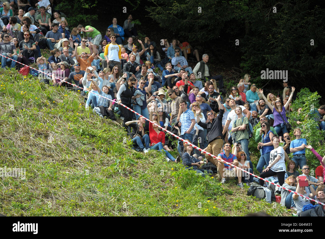 Spectators line the slope for the annual Cheese Rolling event at Coppers Hill near Brockworth, Gloucestershire. Stock Photo