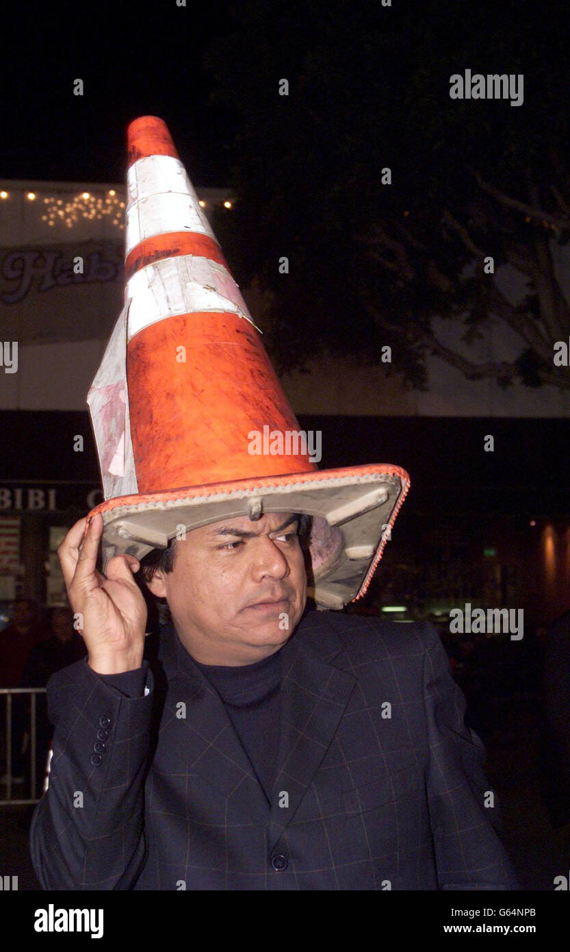Actor George Lopez poses for a photo with a traffic cone on his head at the premiere of the new movie Two Weeks Notice in Los Angeles, Calif. Stock Photo