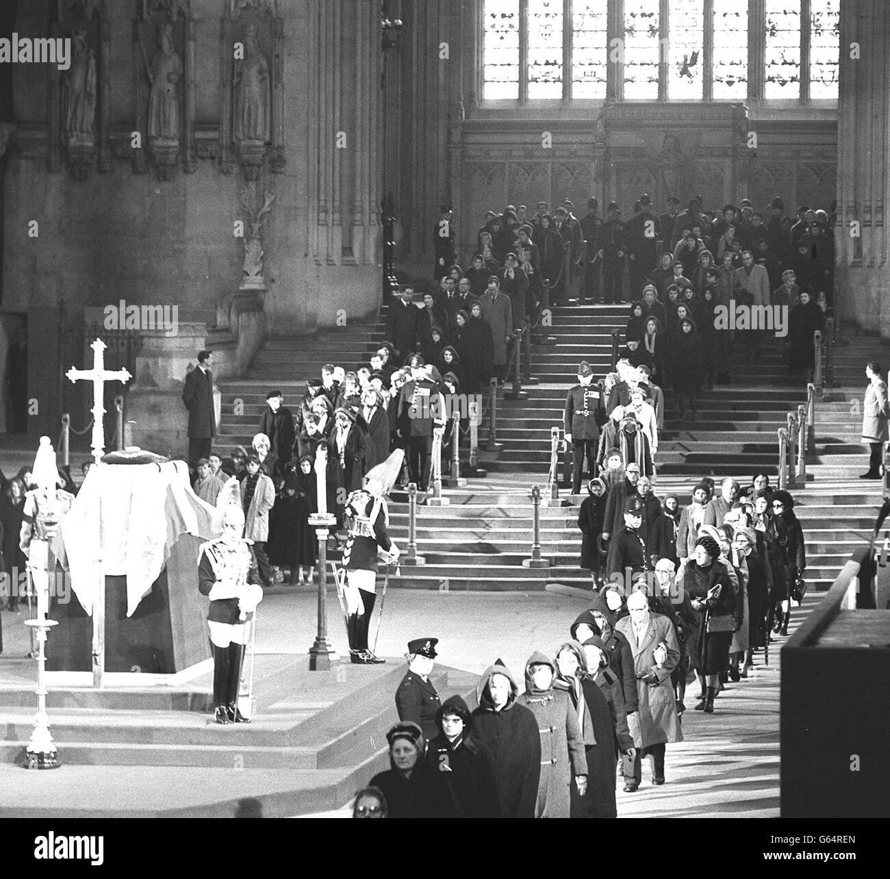 Members of the public at the head of a queue well over half-a-mile long enter Westminster Hall, London, to pay tribute at the Lying-in-State of Sir Winston Churchill. Stock Photo