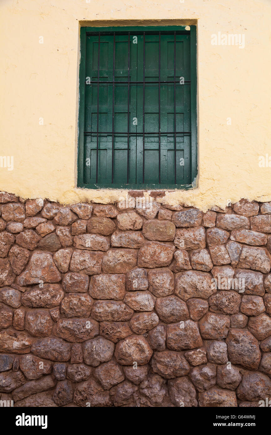 Yellow wall and green window on original Incan foundations in Cusco ...