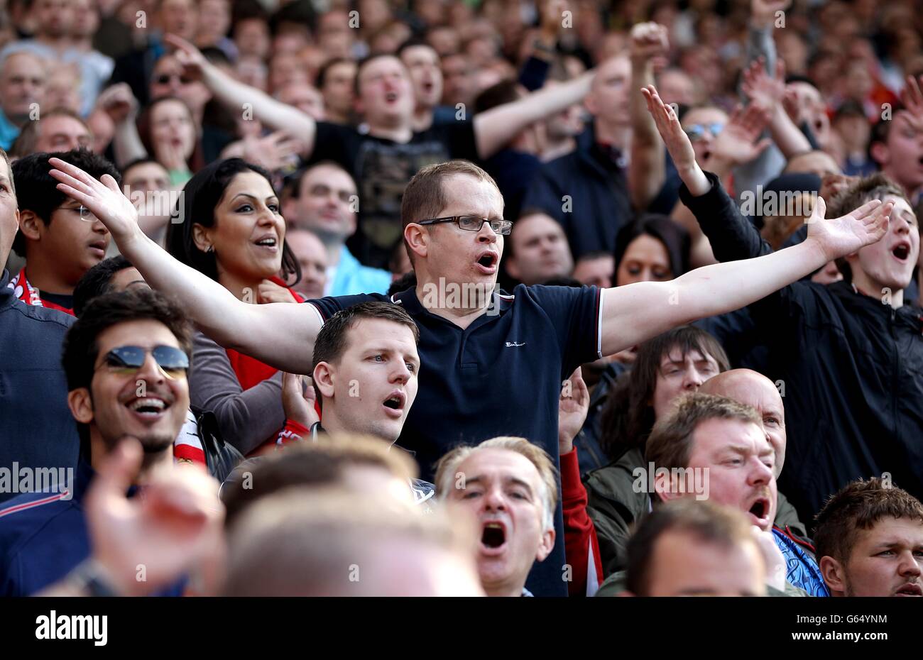 Manchester united fans singing in stands hires stock photography and