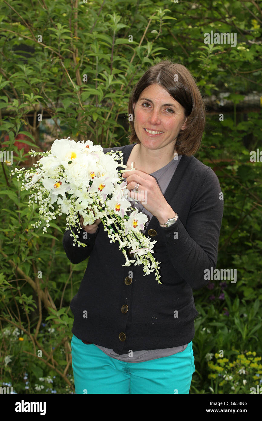Lottie Longman of Longman's Florists, seen in Ilford, Essex, with a replica of the Coronation bouquet which is to be presented to Queen Elizabeth II in celebration of the 60th anniversary of her Coronation. PRESS ASSOCIATION Photo. Picture date: Wednesday May 29, 2013. The granddaughter of the late Martin Longman, of Longman's florists, who made the original bouquet for the monarch in 1953, has crafted a copy of the elaborate ensemble of blooms. Lottie Longman used photos from the Coronation Day and an oil painting of the flowers to help her recreate the exact bouquet, having spent six months Stock Photo