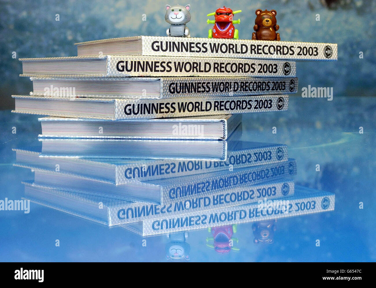 Some of the original micro pets (from left) Chumsley, Yuk and Kuma, sit on top of copies of the Guinness Book of Records in central London, after the Tomy toys were officially awarded a Guinness World Record for the Worlds's Smallest Self-Powered Sound-Activated Toy. * The toys respond to both voice commands and hand clapping sequences. Stock Photo