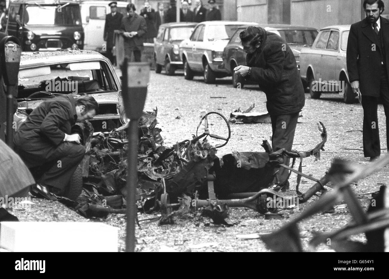 Police examine the remains of the bomb car after the blast at Horseferry House, Westminster, which injured scores of people. Stock Photo