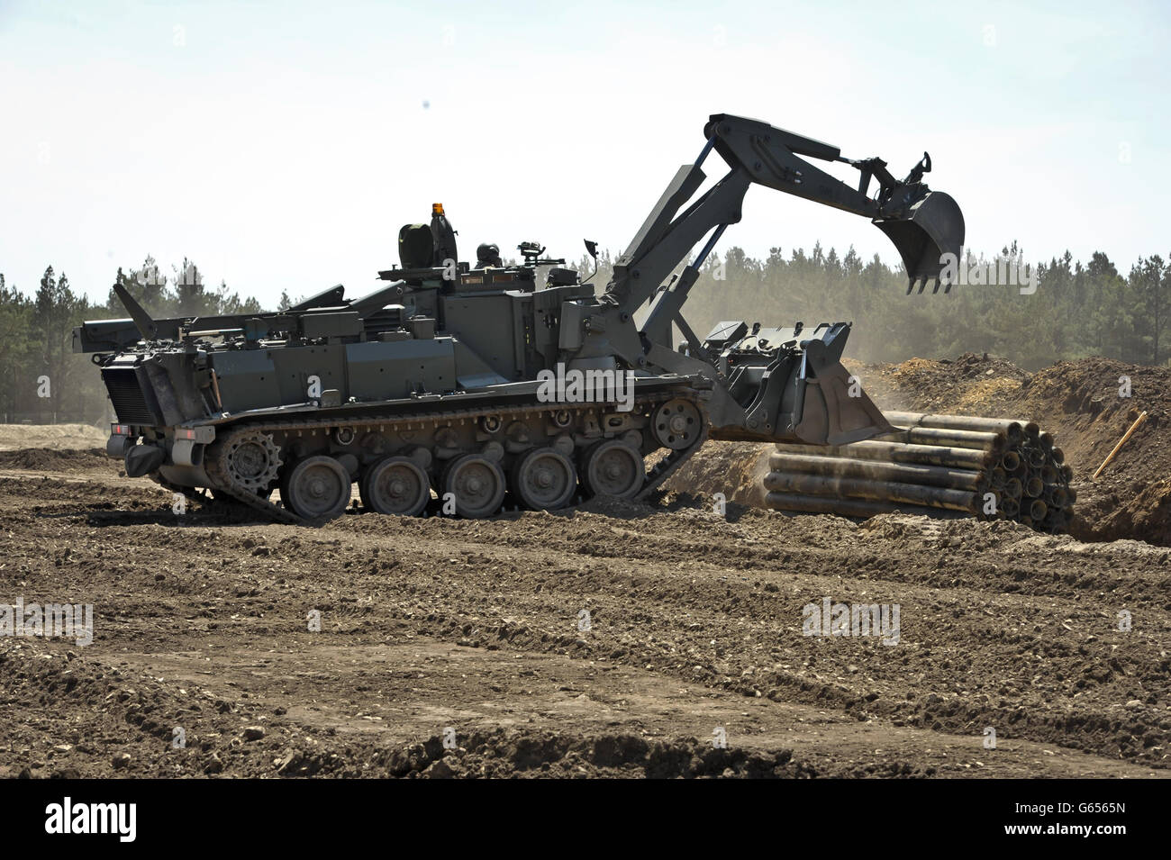 A Terrier armoured digger, which can be controlled by remote control, is driven by a soldier as it is displayed and put through its paces during an unveilling at the Defence Armoured Vehicle Centre, Bovington, Dorset. Stock Photo
