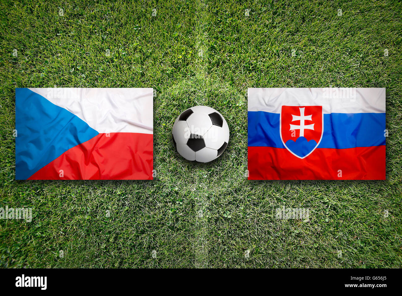 Czech Republic vs. Slovakia flags on green soccer field Stock Photo