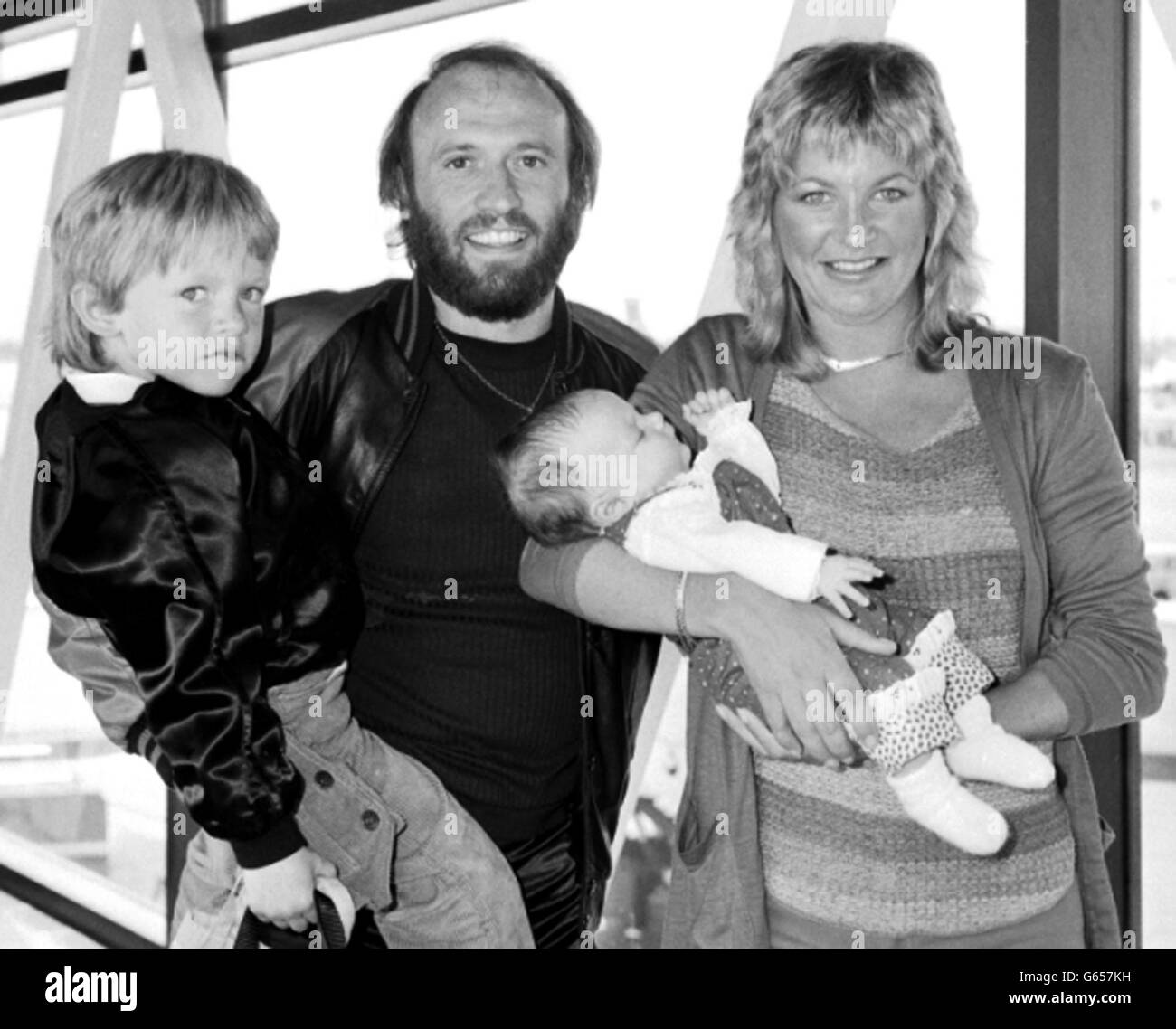 Bee Gee Maurice Gibb with his wife, Yvonne, and their children Adam, four, and seven week old Samantha, at London's Heathrow airport when they arrived from New York, USA. They were here for two weeks to show the baby to relatives. 12/01/03 : Bee Gee Maurice Gibb with his wife, Yvonne, and their children Adam, four, and seven week old Samantha, at London's Heathrow airport when they arrived from New York, USA. Gibb died in hospital his family said. The 53-year-old had been in a critical condition in hospital after suffering a heart attack during an operation to remove an intestinal blockage Stock Photo