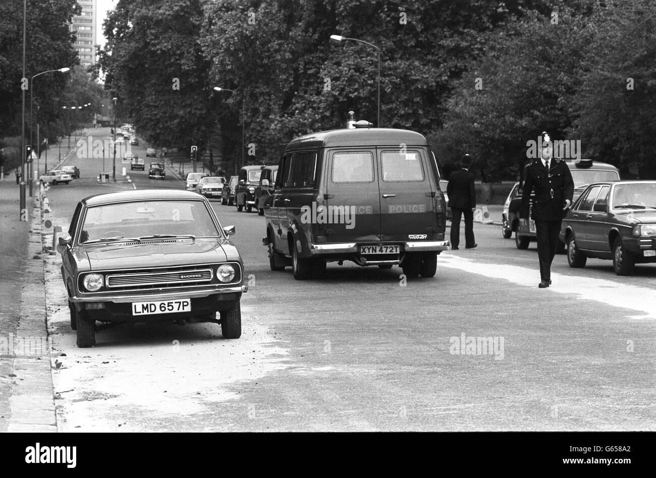 Police activity on South Carriage Road, Hyde Park, London, where the bomb exploded killing three members of the Blues and Royals. The car (left) is similar to the Blue Marina, with the same registration number, that contained the radio-controlled bomb in its boot. Stock Photo