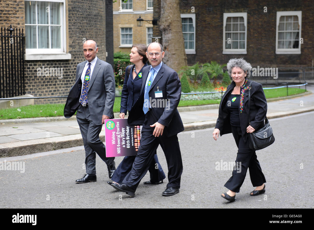 Laurence Buckman (second right) Chairman of the British Medical Association holds a petition for the Prime Minister, outside number 10, Downing St with Beth McCarron-Nash (second left) a member of the GP Committee, Prit Buttar (left) also a member, and Natalie Teiach BMA patient liason group (right), this afternoon. Stock Photo