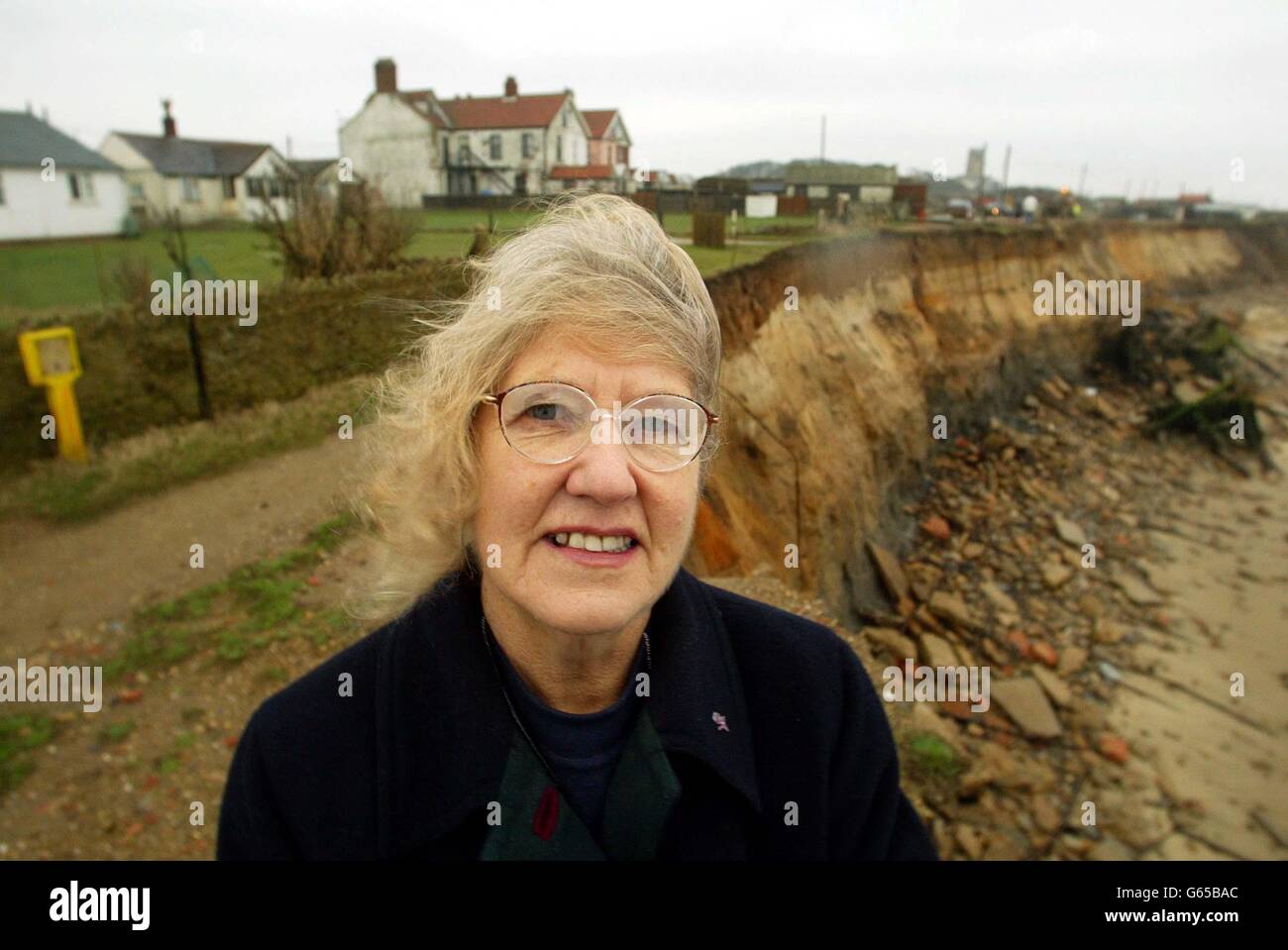 Diana Wrighton whose Cliff House guest house in Happisburgh, Norfolk is four metres from the cliff edge. Mrs Wrightson's home is getting closer to the sea due to coastal erosion the local council are now placing big rocks at the bottom of the cliff to stop the sea . * Emergency works are underway in an attempt to allow residents to stay in their cliff-side homes for Christmas, a council said Monday December 16, 2002. About six properties in the coastal village of Happisburgh have already fallen victim to the encroaching North Sea. Stock Photo