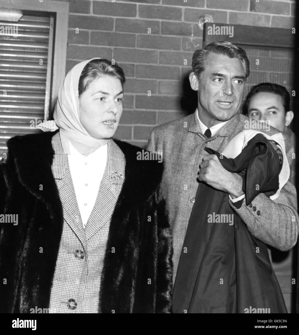 Ingrid Bergman and Cary Grant - London Airport. Actress Ingrid Bergman and actor Cary Grant who met her at London Airport after she arrived from Rome. Stock Photo