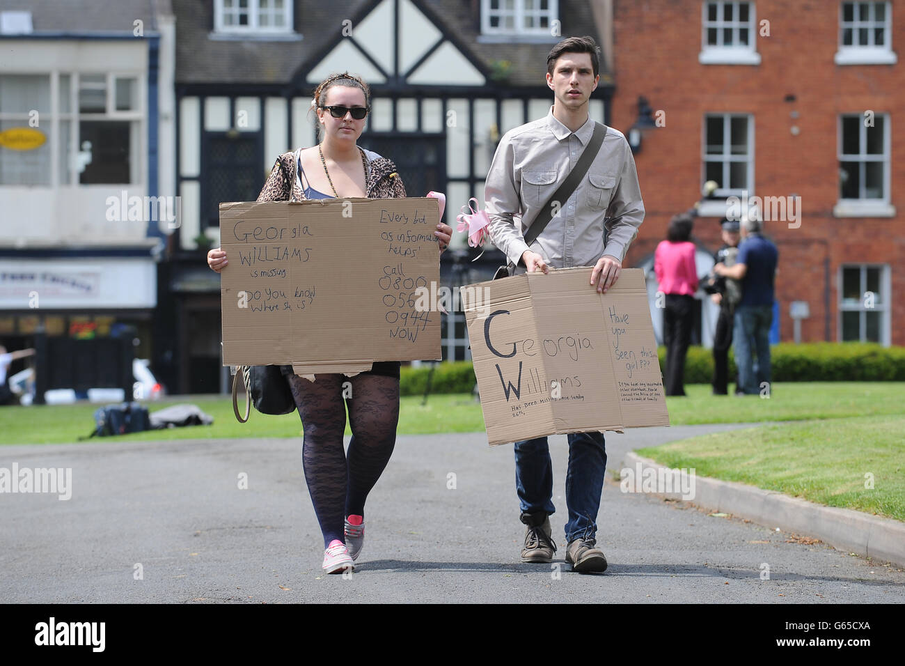 Natasha Wade, 19 from Newport (left) and Liam Ball, 18 from Shifnal, friends of Georgia Williams, carry signs around Wellington, Shropshire as the search for the missing girl goes on. Stock Photo