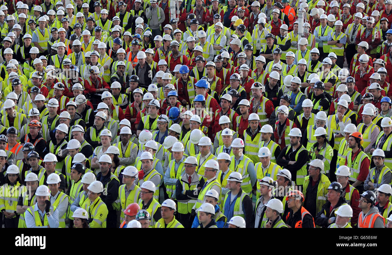 Workers gather together in the departures hall of Heathrow's Terminal 2 for a talk by Developing Director John Holland-Kaye during a media day marking One Year to Go until Terminal 2 re-opens. Stock Photo