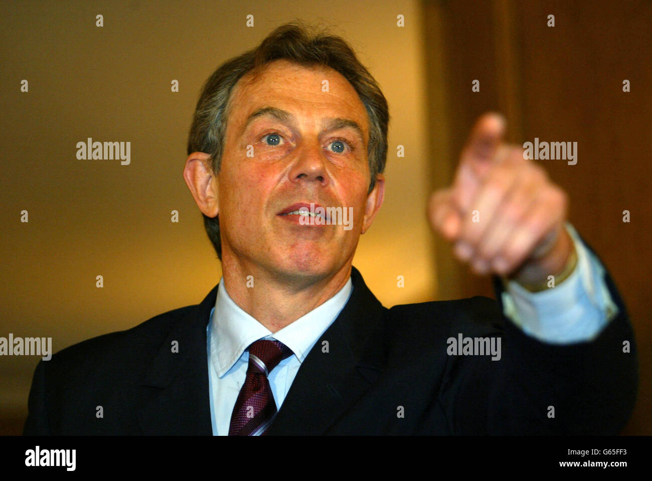 Britain's Prime Minister Tony Blair talks to the press inside London's No. 10 Downing Street, London. Blair said that the Iraqi leader Saddam Hussein can still peacefully end the standoff over weapons of mass destruction. * but warned that he will be disarmed by force if he does not. Stock Photo