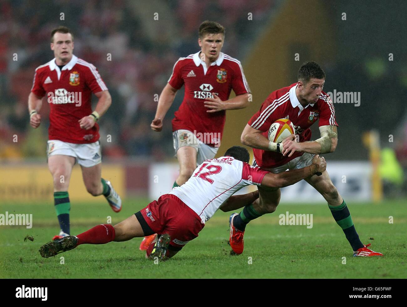 British and Irish Lions' Alex Cuthbert is tackled by Queensland Reds' Anthony Faingaa Stock Photo