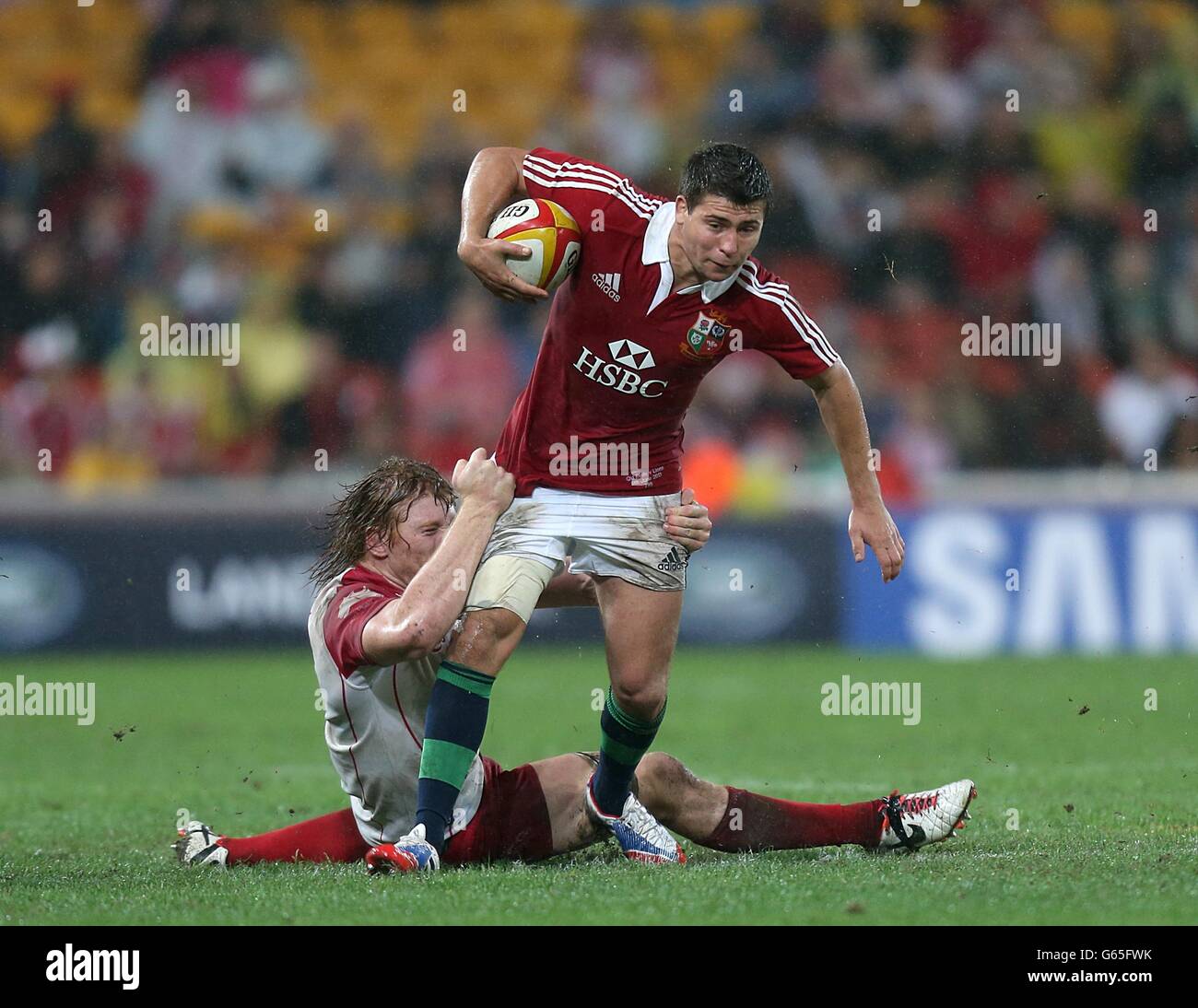 British and Irish Lions' Ben Youngs is tackled by Queensland Reds' Ed Quirk Stock Photo