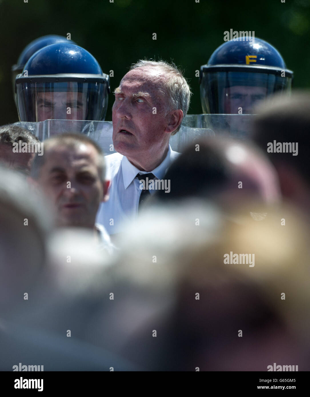 A member of the colour party surrounded by Garda at the burial of former Republican Sinn Fein leader Ruairi O Bradaigh at St. Coman's Cemetery, Roscommon. PRESS ASSOCIATION Photo. Picture date: Saturday June 8, 2013. Photo credit should read: Barry Cronin/PA Wire Stock Photo