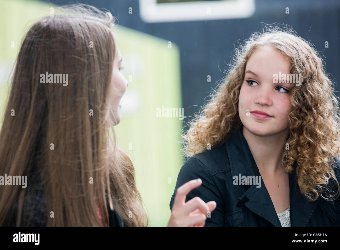 Teenage girls talking outside, 16 17 years age, summer Stock Photo