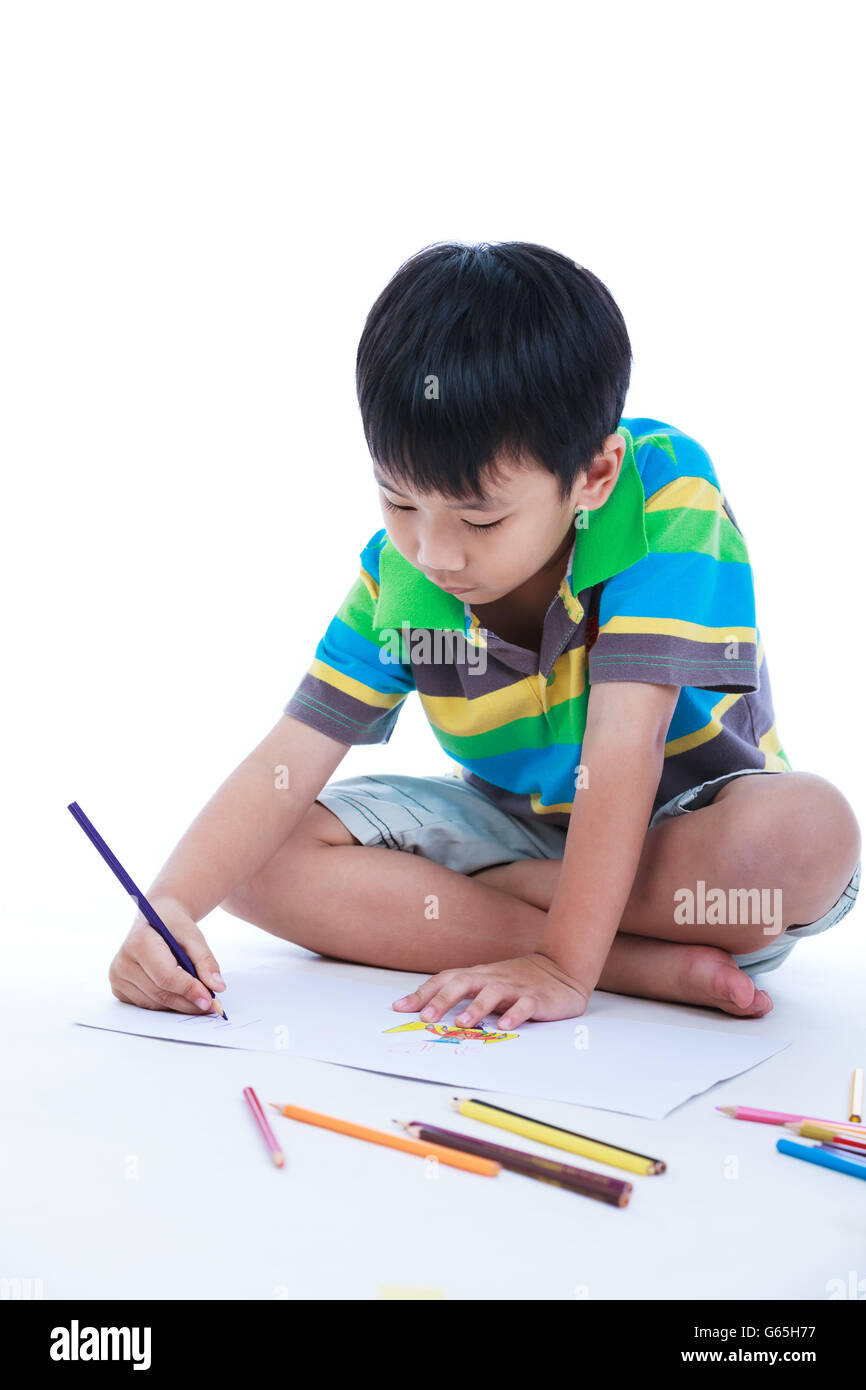 Handsome asian boy sitting on the floor and drawing on his artwork. Concepts of creativity and education, strengthen the imagina Stock Photo