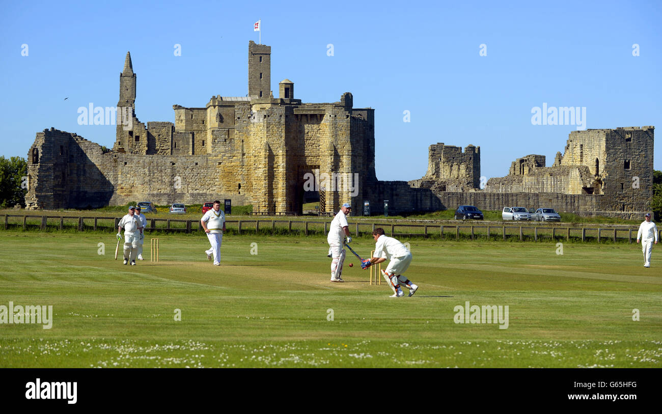 A cricket match takes place this weekend, with Warkworth Castle as a backdrop. Stock Photo