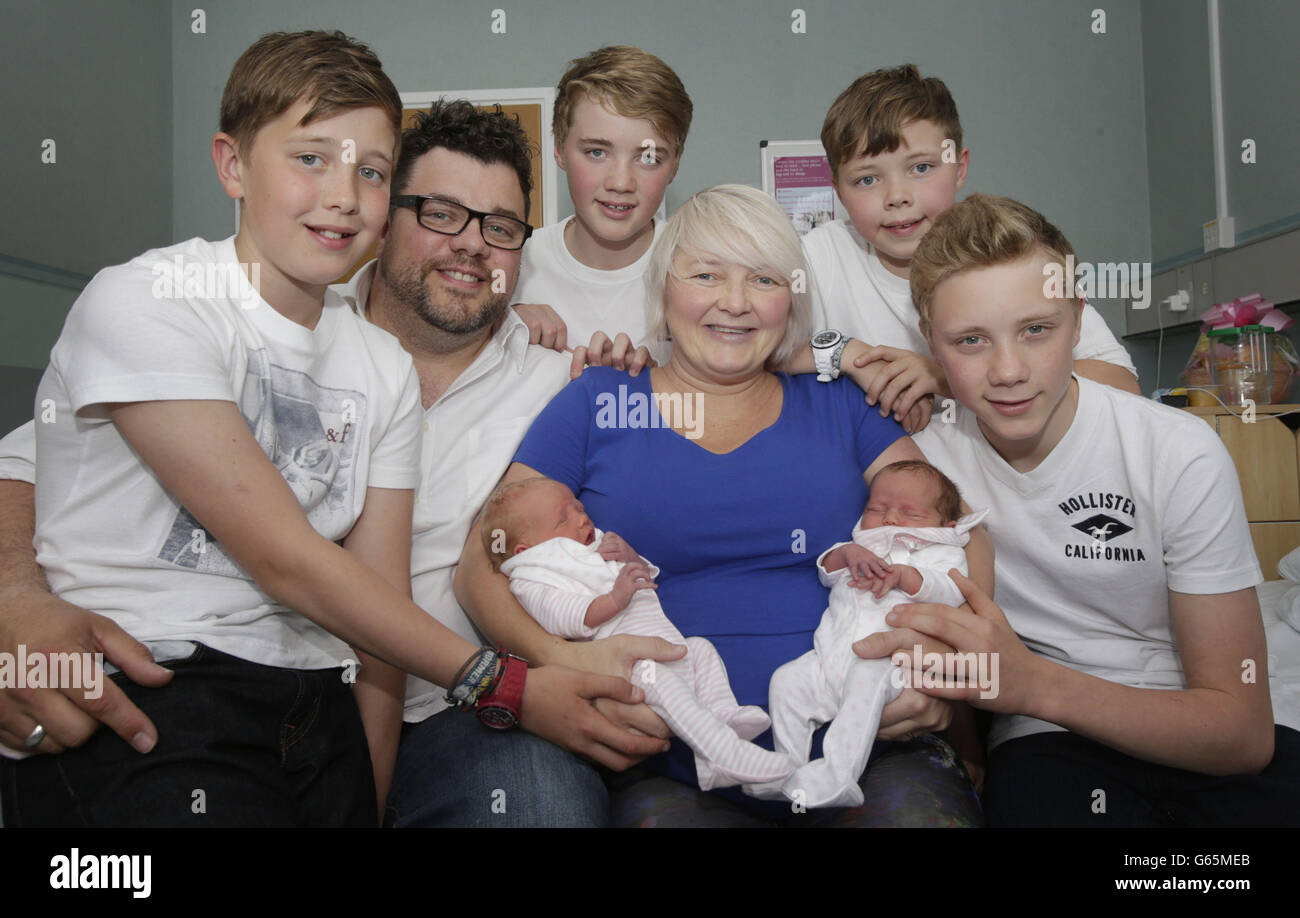 Mother Karen Rodger who defied the odds by becoming pregnant with her third set of twins, is pictured holding her newborns Rowan (left) and Isla (right) with with husband Colin Rodger (2nd left) and their sons left to right Finn, Lewis, Jude and Kyle at the Southern General Hospital in Glasgow. Stock Photo
