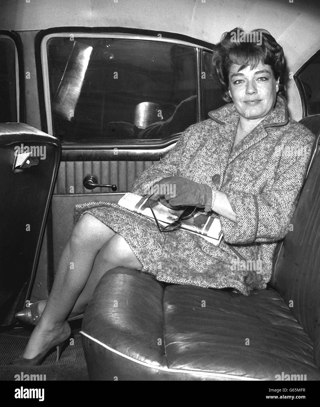 French film-actress Simone Signoret seated in a car after arriving at London Airport from Paris. Stock Photo